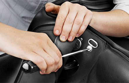 Removing the screw under the skirt at the head of the saddle.